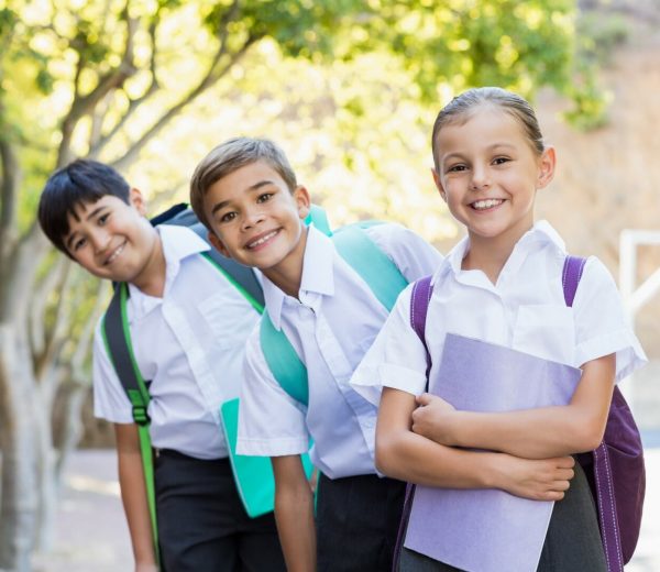 Portrait,Of,Smiling,School,Kids,Standing,In,Campus,With,Books